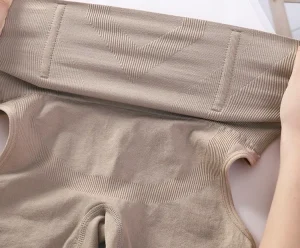Close-up of beige lingerie fabric showcasing quality and texture.