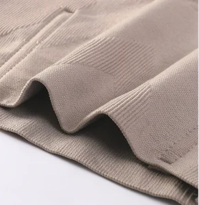 High-quality beige lingerie fabric showcasing fine stitching and soft texture for comfortable wear.